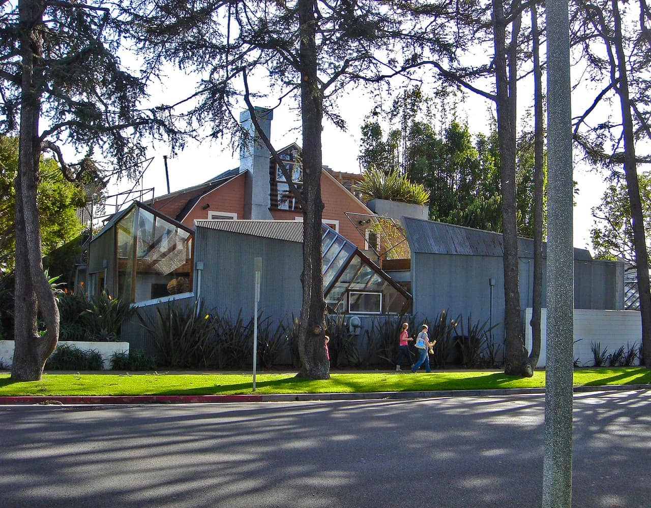Frank Gehry House in Santa Monica, where exposed framing and unconventional materials wrap and interrupt the original suburban home.